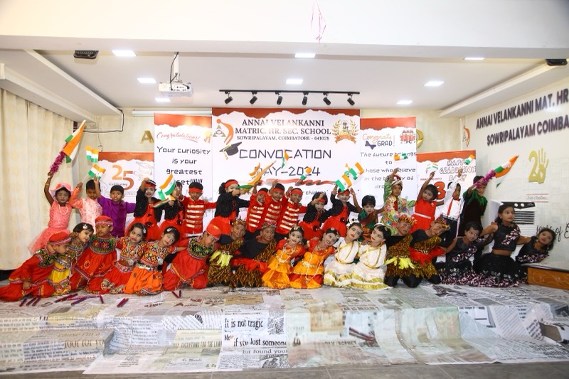 Students in folk costume with tricolour flags at Convocation Day, Annai Velankanni School, Coimbatore