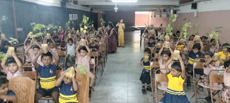 Students holding saplings during a tree plantation campaign, Annai Velankanni School, Coimbatore
